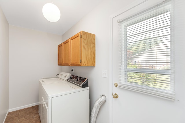 laundry room with cabinets, tile patterned floors, and washer and clothes dryer