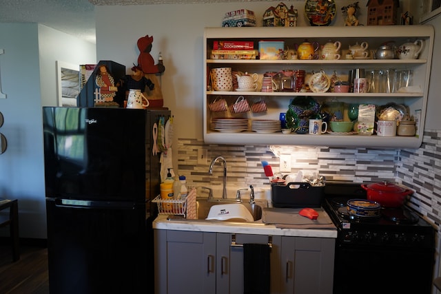 kitchen with black appliances, sink, decorative backsplash, gray cabinets, and dark hardwood / wood-style flooring