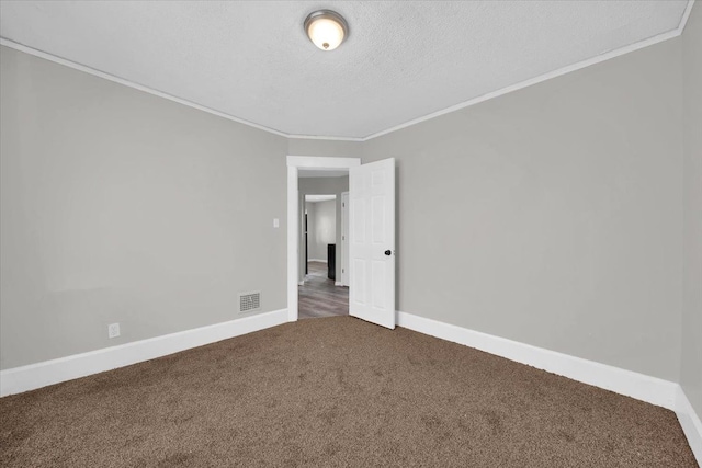 carpeted spare room with crown molding and a textured ceiling