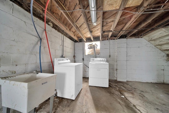 clothes washing area with independent washer and dryer and sink