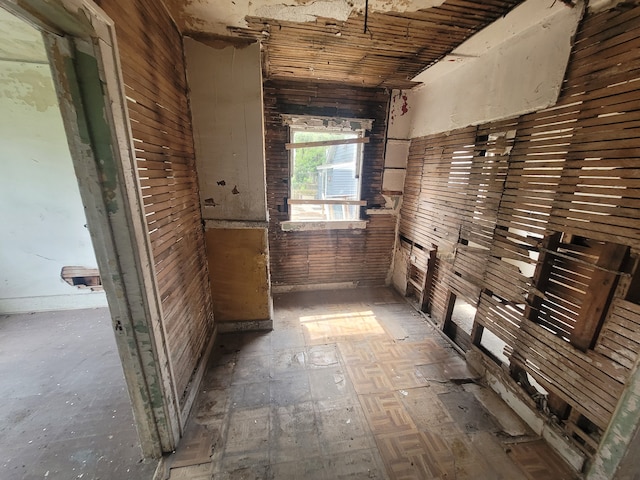 hallway with wood walls