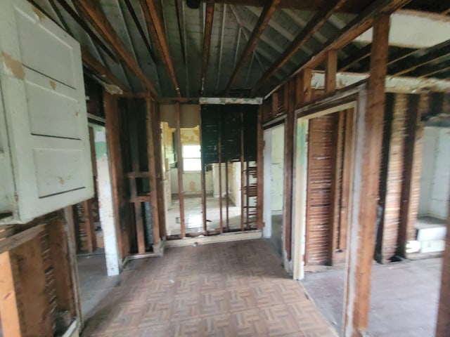 misc room featuring parquet flooring and electric panel