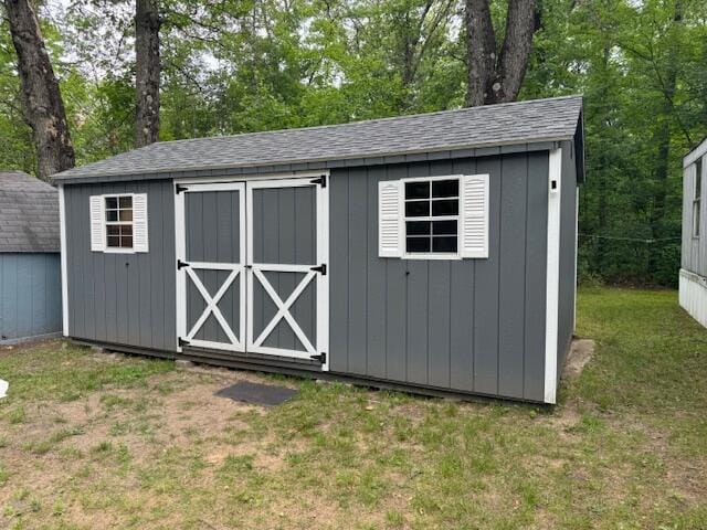 view of outbuilding featuring a lawn