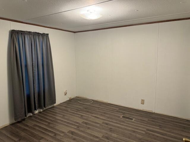 spare room with dark hardwood / wood-style floors and crown molding