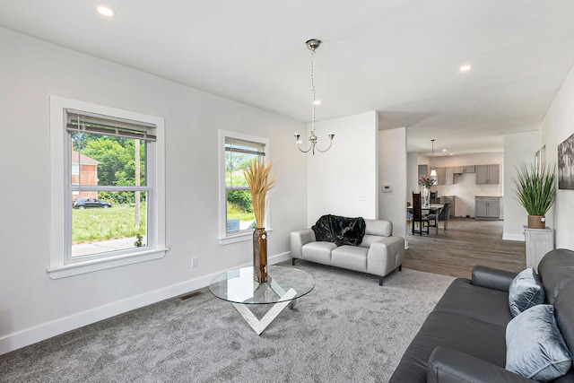 living room featuring hardwood / wood-style flooring and a notable chandelier