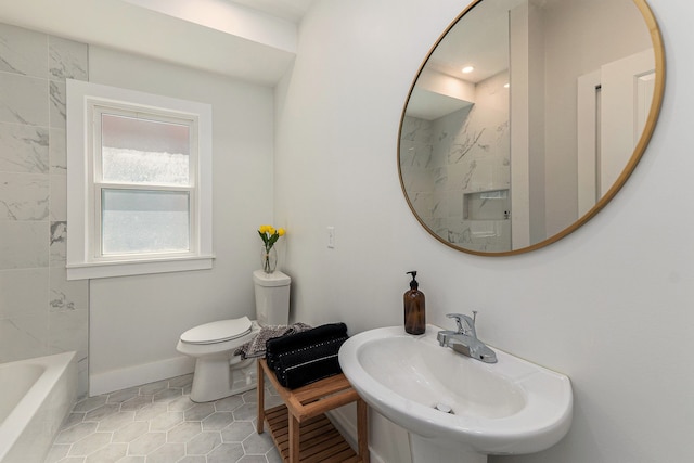 bathroom featuring toilet, tile patterned floors, and sink