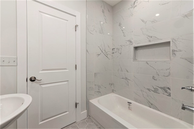 bathroom featuring tile patterned floors, sink, and tiled shower / bath