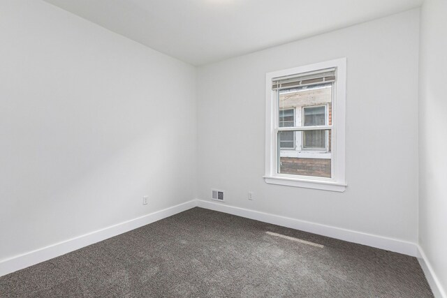 392 Philip St, Detroit, MI 48215 - empty room with dark colored carpet and baseboards