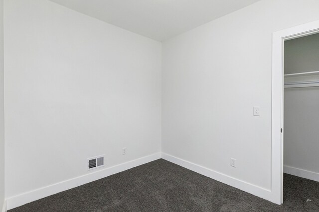 392 Philip St, Detroit, MI 48215 - unfurnished bedroom featuring dark carpet, baseboards, and a closet