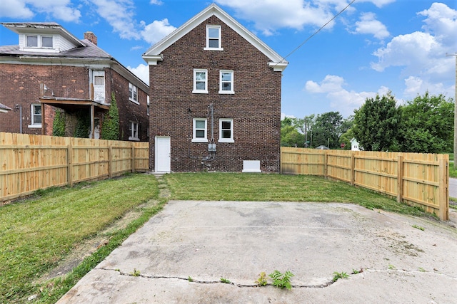 rear view of property with a patio area and a yard