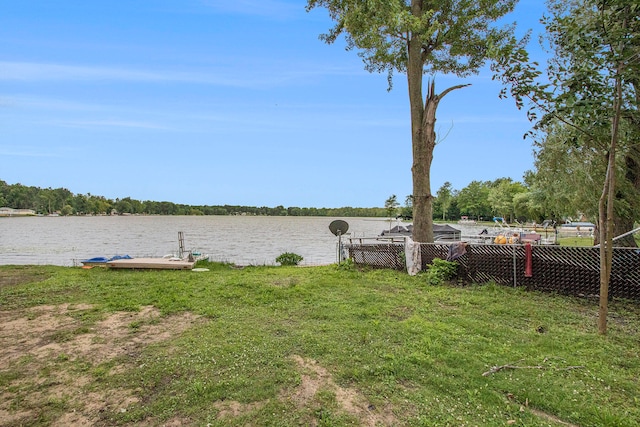 view of yard featuring a boat dock and a water view