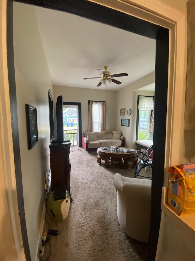 carpeted living room featuring ceiling fan