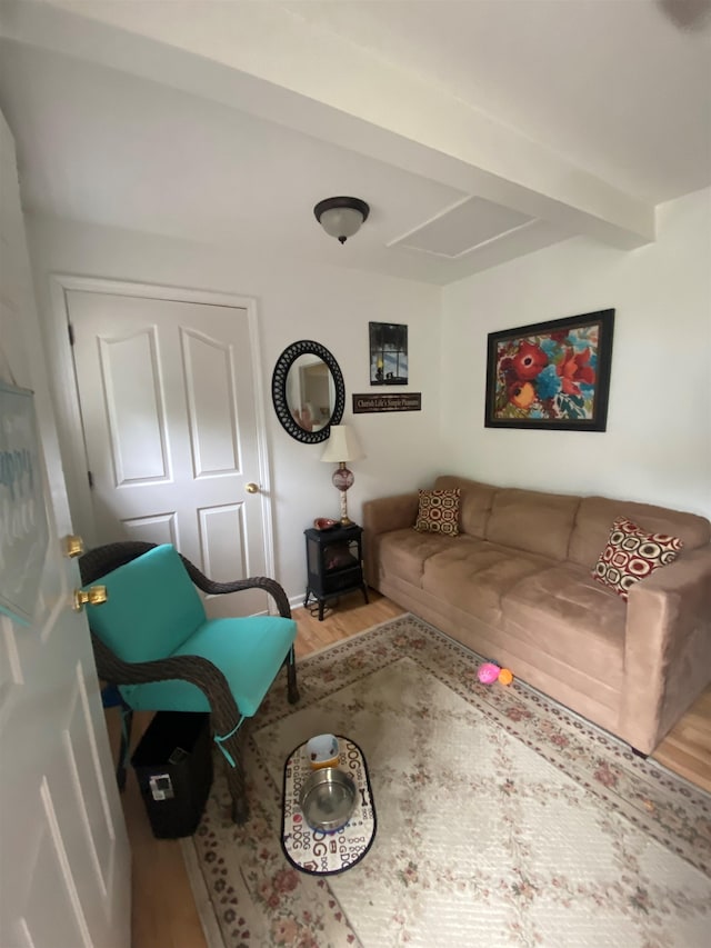 unfurnished living room featuring beamed ceiling and wood-type flooring