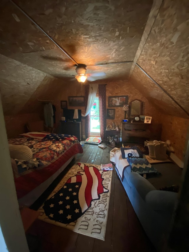 bedroom featuring ceiling fan, lofted ceiling, and hardwood / wood-style flooring