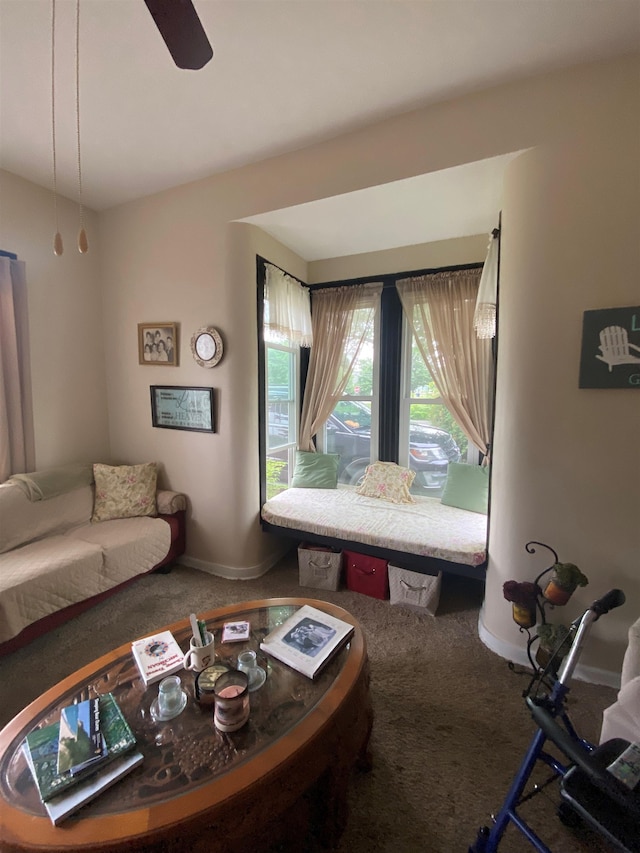 carpeted living room with ceiling fan