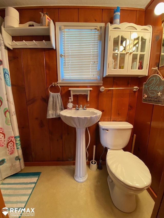 6344 W Houghton Lake Rd, Houghton Lake, MI 48629 - bathroom with toilet, wooden walls, and a shower with shower curtain