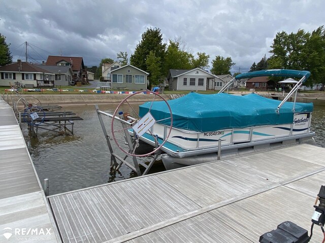 6344 W Houghton Lake Rd, Houghton Lake, MI 48629 - dock area featuring boat lift, a residential view, and a water view