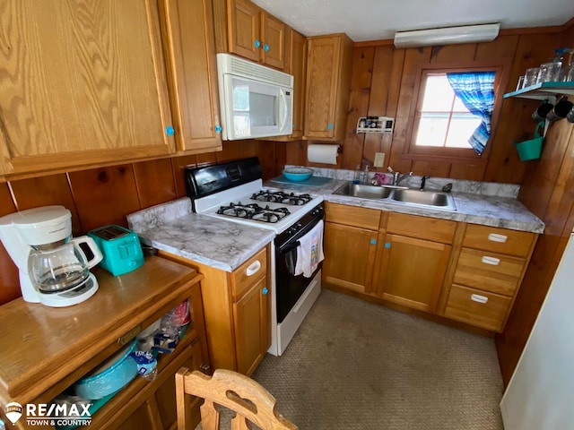 kitchen with white appliances, dark carpet, and sink