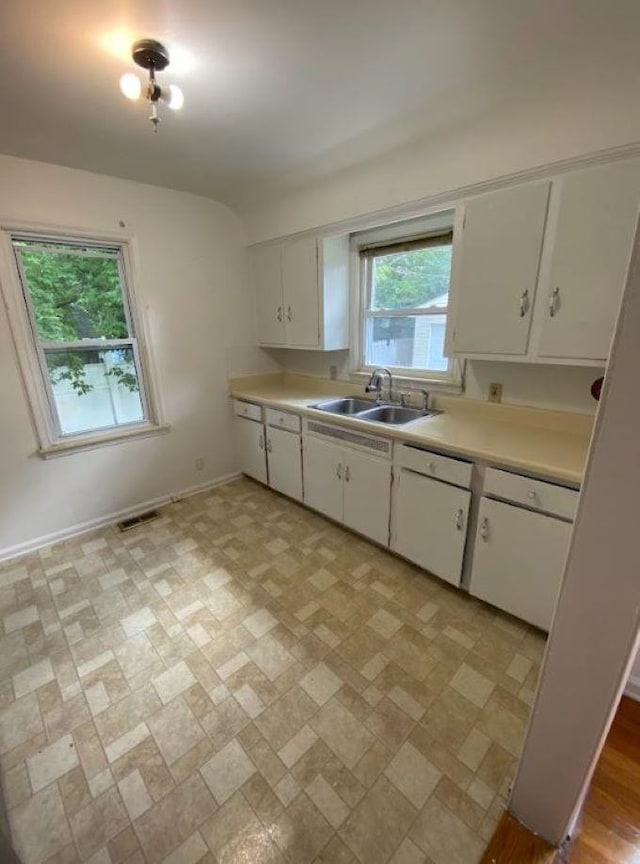 kitchen featuring white cabinetry and sink