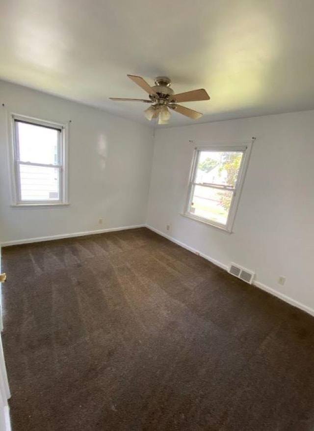 carpeted empty room featuring ceiling fan