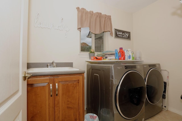 807 War Bonnet Dr, Tecumseh, MI 49286 - washroom featuring washing machine and dryer, a sink, cabinet space, and light tile patterned floors