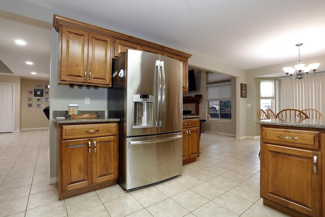807 War Bonnet Dr, Tecumseh, MI 49286 - kitchen with stainless steel fridge with ice dispenser, a chandelier, and brown cabinets