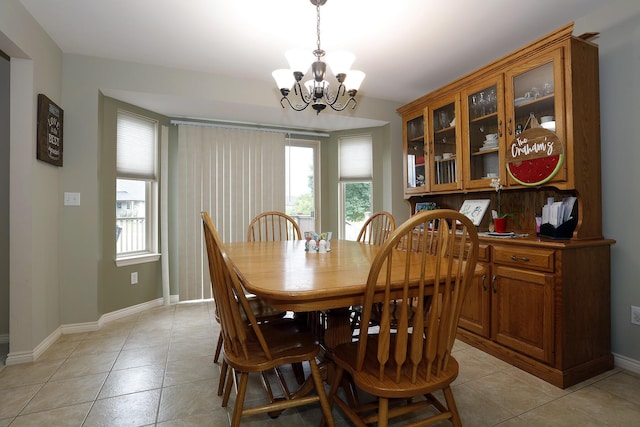 807 War Bonnet Dr, Tecumseh, MI 49286 - dining room featuring an inviting chandelier, light tile patterned floors, plenty of natural light, and baseboards