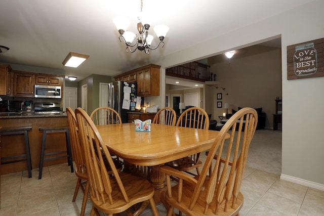 807 War Bonnet Dr, Tecumseh, MI 49286 - dining space with baseboards, an inviting chandelier, and light tile patterned floors