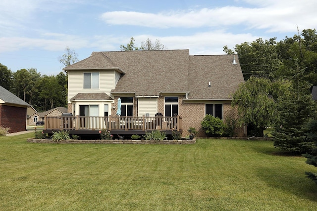 807 War Bonnet Dr, Tecumseh, MI 49286 - view of front of home featuring a front lawn, a wooden deck, brick siding, and roof with shingles