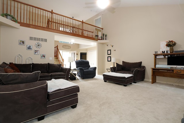 807 War Bonnet Dr, Tecumseh, MI 49286 - living room featuring high vaulted ceiling, visible vents, ceiling fan, stairway, and carpet floors