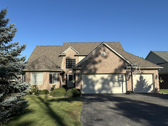 807 War Bonnet Dr, Tecumseh, MI 49286 - view of front of home featuring brick siding, driveway, roof with shingles, and an attached garage