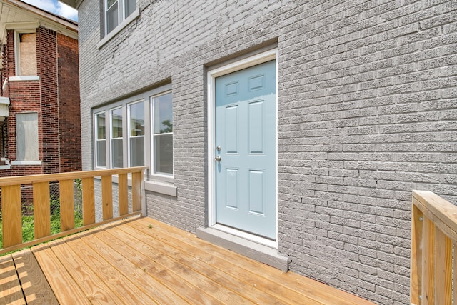 view of exterior entry with a wooden deck