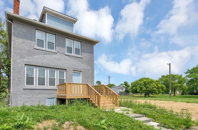 back of house featuring a wooden deck