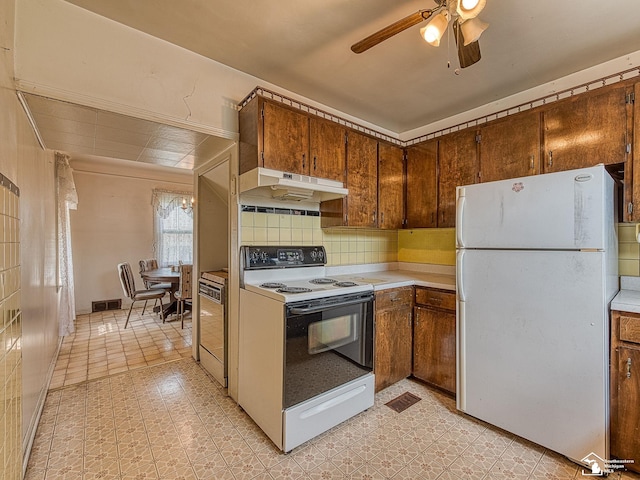 kitchen with decorative backsplash, ceiling fan, and white appliances