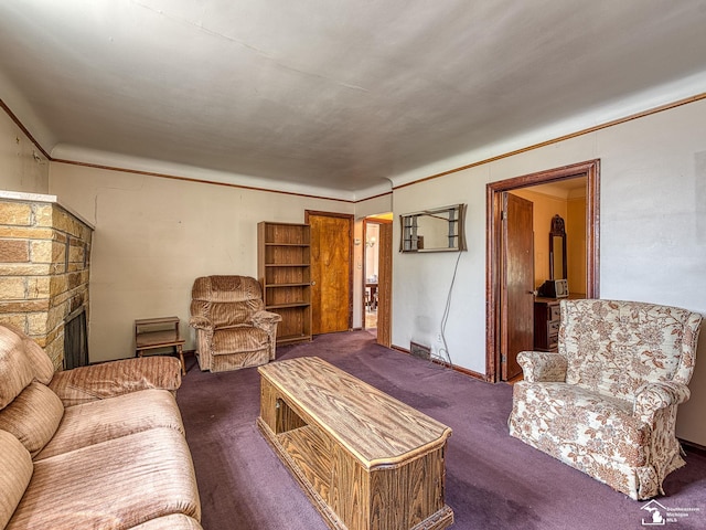 living room featuring dark colored carpet and a stone fireplace