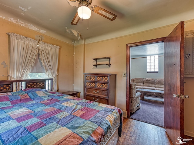 bedroom with wood-type flooring and ceiling fan