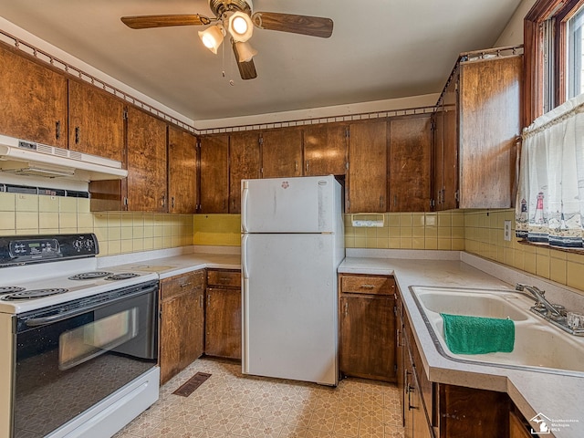 kitchen featuring ceiling fan, white appliances, sink, and tasteful backsplash