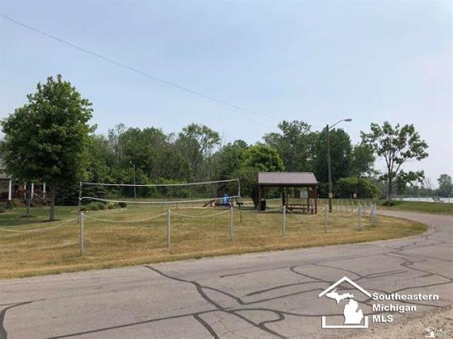 surrounding community featuring a lawn, a gazebo, and volleyball court