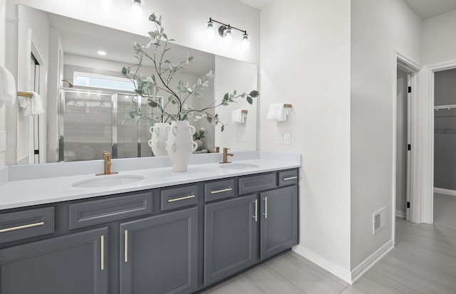 bathroom featuring an enclosed shower and vanity