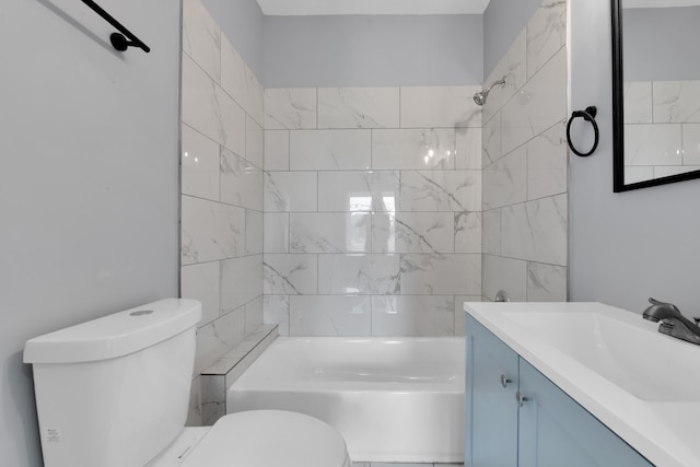 full bathroom featuring vanity, toilet, and tiled shower / bath