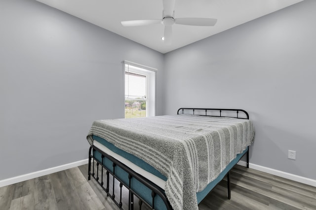 bedroom featuring ceiling fan and dark wood-type flooring