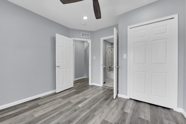 unfurnished bedroom featuring ceiling fan, light wood-type flooring, and a closet