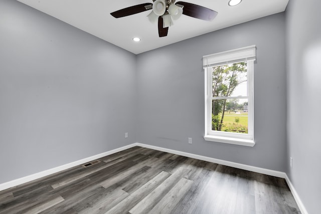 empty room featuring ceiling fan and dark wood-type flooring