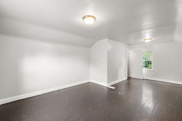 additional living space featuring dark hardwood / wood-style floors and vaulted ceiling