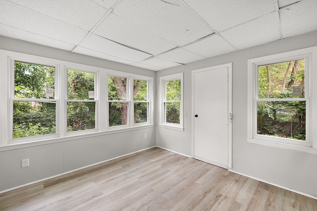 unfurnished sunroom featuring a paneled ceiling