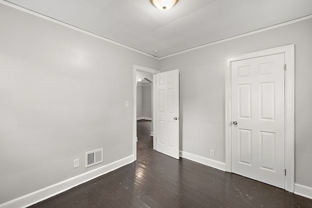 unfurnished bedroom with dark hardwood / wood-style flooring