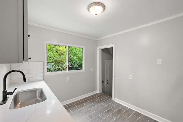 laundry room featuring crown molding, sink, and dark hardwood / wood-style floors