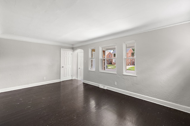 unfurnished room featuring wood-type flooring and crown molding