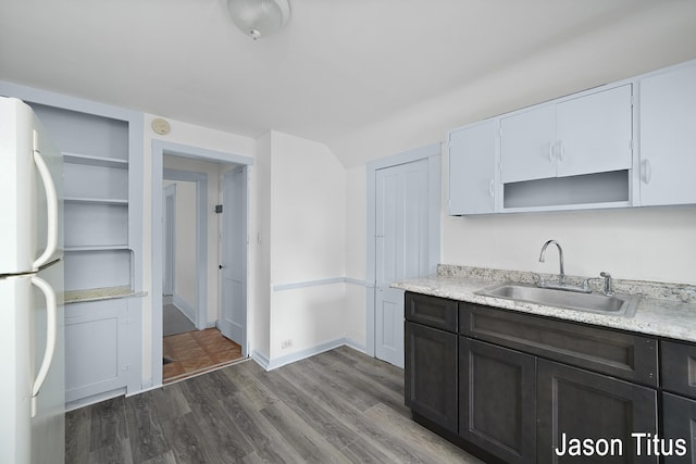 kitchen featuring white fridge, dark hardwood / wood-style flooring, and sink