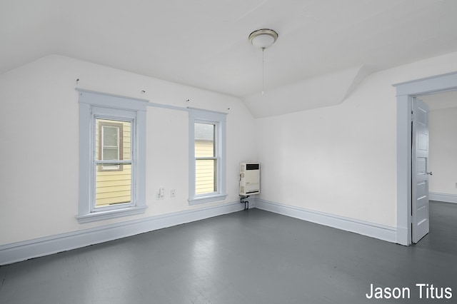 bonus room with heating unit and lofted ceiling